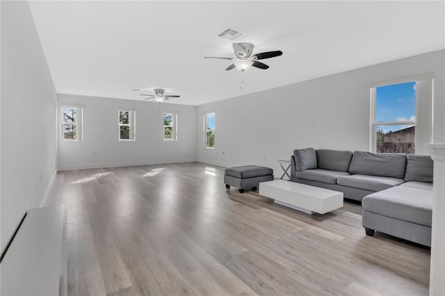 living room featuring ceiling fan and light hardwood / wood-style flooring