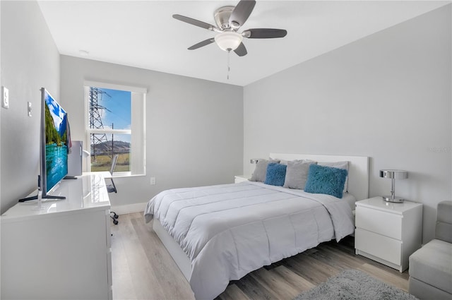 bedroom featuring ceiling fan and light hardwood / wood-style flooring