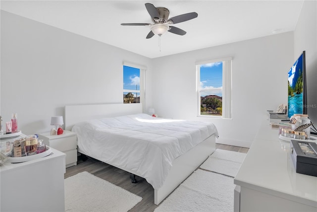 bedroom with ceiling fan and light hardwood / wood-style floors