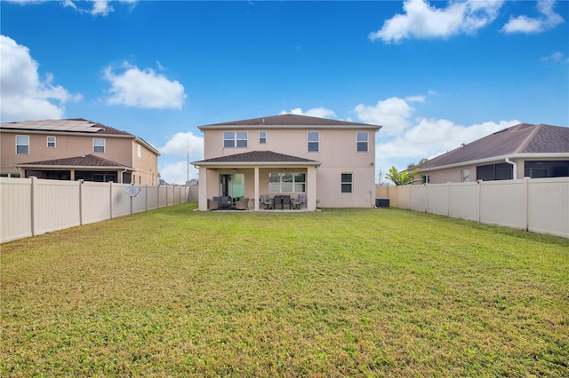 rear view of property with a yard, a patio, and central air condition unit