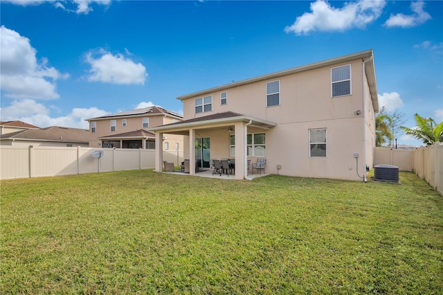 rear view of house featuring a patio, a yard, and central air condition unit