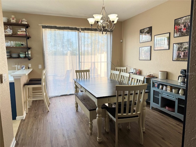 dining space with wood-type flooring and a chandelier