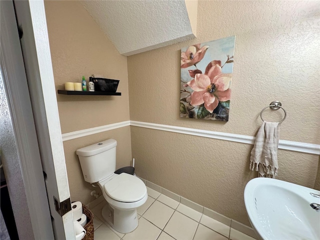 bathroom with tile patterned flooring, sink, and toilet