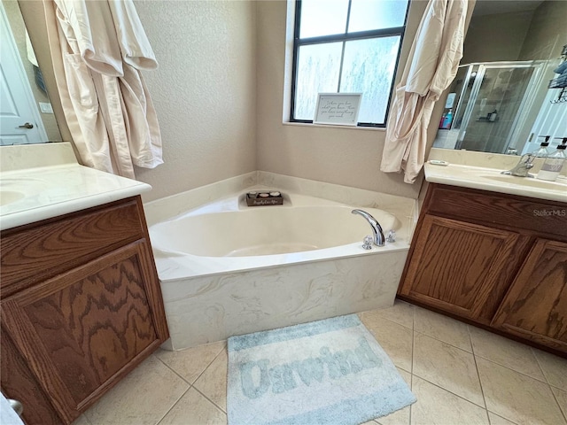 bathroom featuring vanity, shower with separate bathtub, and tile patterned flooring