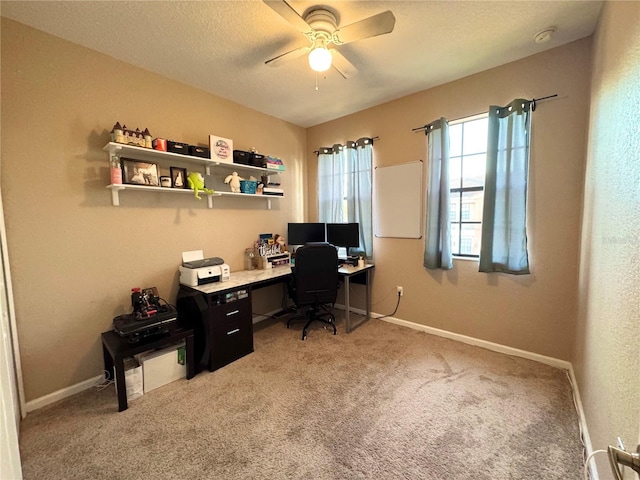 home office with carpet, a textured ceiling, and ceiling fan