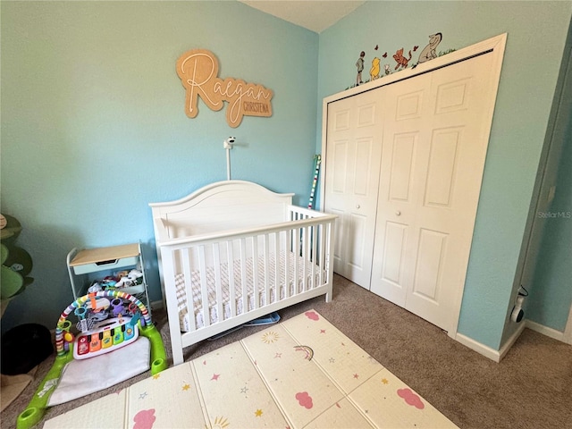 carpeted bedroom featuring a nursery area and a closet