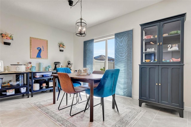 dining area featuring an inviting chandelier and light tile patterned floors