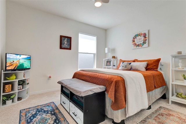 bedroom featuring light colored carpet and ceiling fan