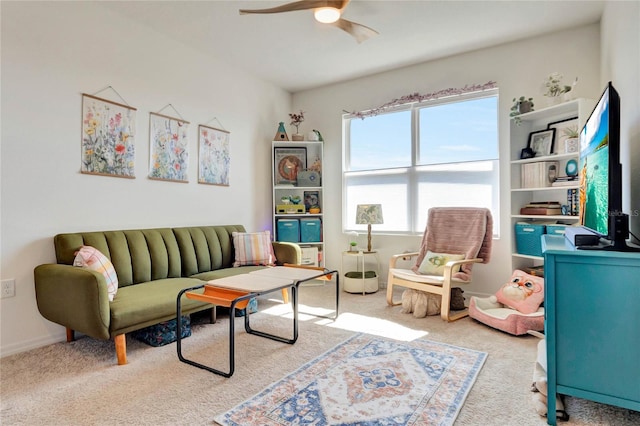 carpeted living room with ceiling fan