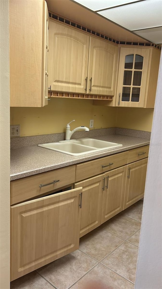 kitchen featuring light tile patterned flooring, sink, and light brown cabinets