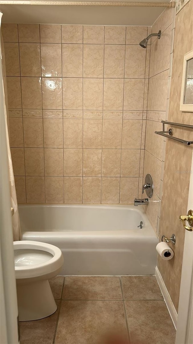 bathroom featuring shower / bathtub combination with curtain, tile patterned floors, and toilet