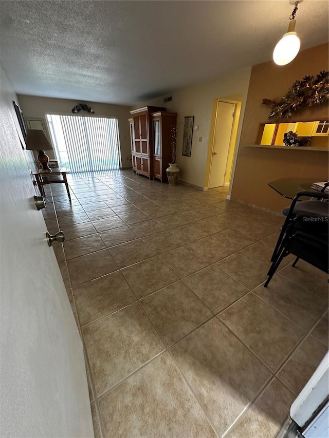 interior space featuring a textured ceiling and tile patterned floors