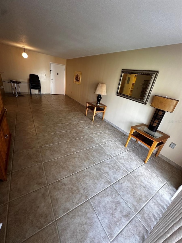 interior space with tile patterned flooring and a textured ceiling