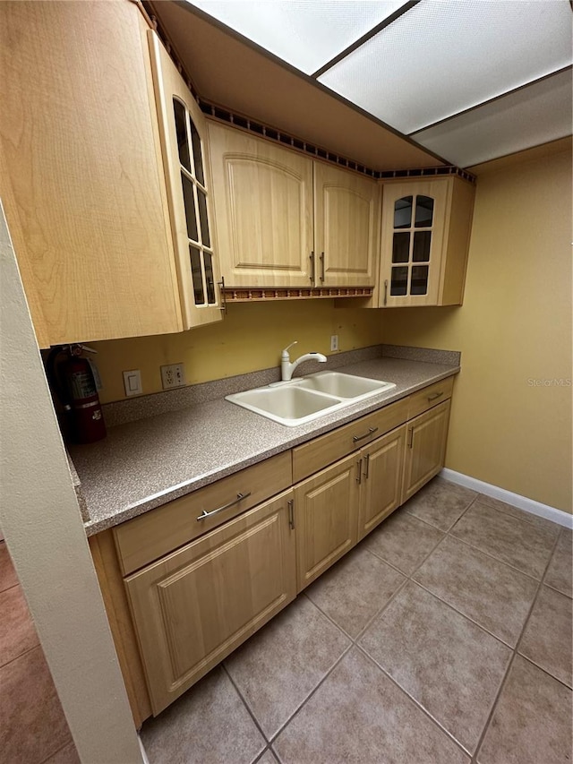 kitchen featuring light tile patterned floors, sink, and light brown cabinets