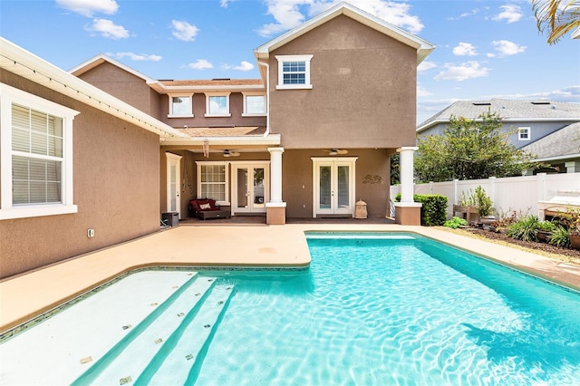 view of pool featuring a fenced in pool, a patio, ceiling fan, fence, and french doors