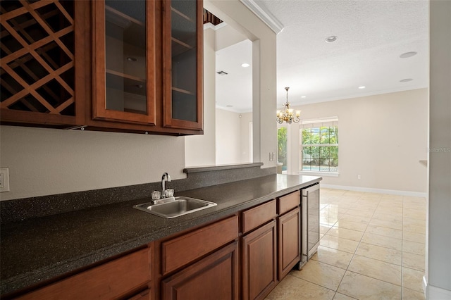 kitchen with dark countertops, glass insert cabinets, brown cabinetry, and a sink