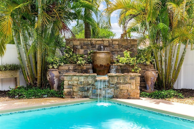 view of swimming pool with fence and a fenced in pool