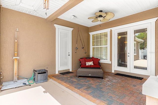 doorway to property with a ceiling fan, french doors, a patio area, and stucco siding