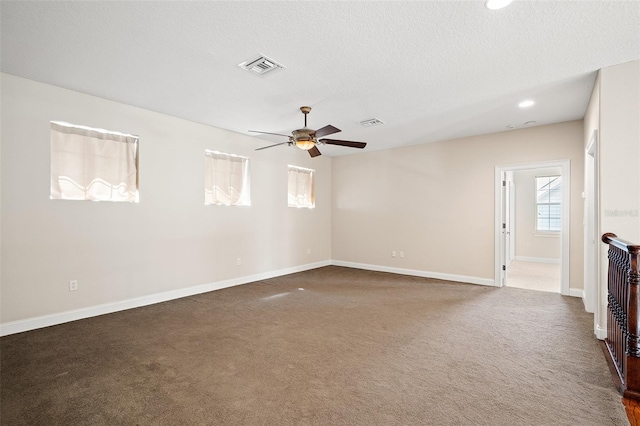 carpeted empty room with baseboards, visible vents, a ceiling fan, a textured ceiling, and recessed lighting