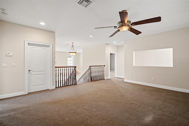 carpeted spare room with baseboards, visible vents, and recessed lighting