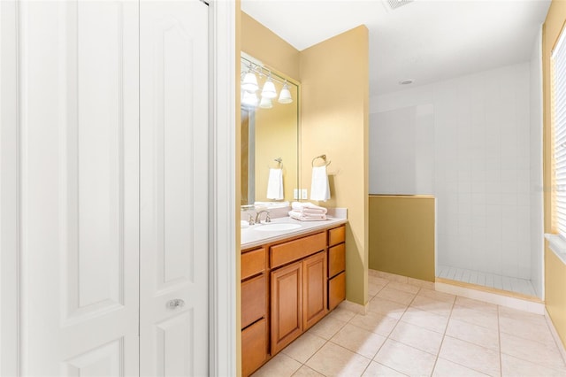 full bath with a walk in shower, visible vents, tile patterned flooring, and vanity