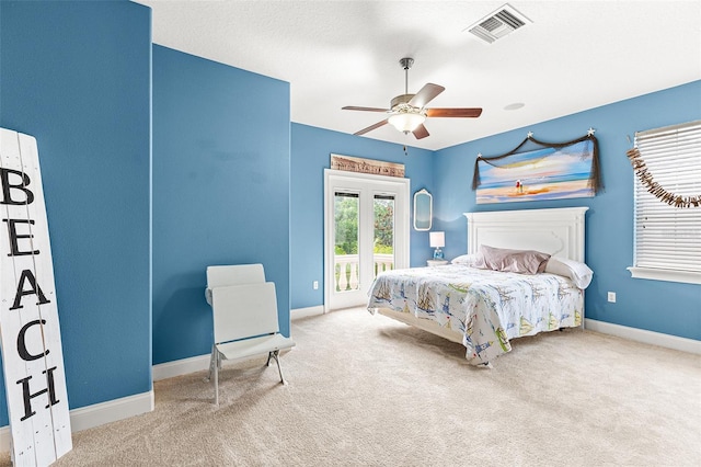 carpeted bedroom with access to outside, a ceiling fan, visible vents, and baseboards