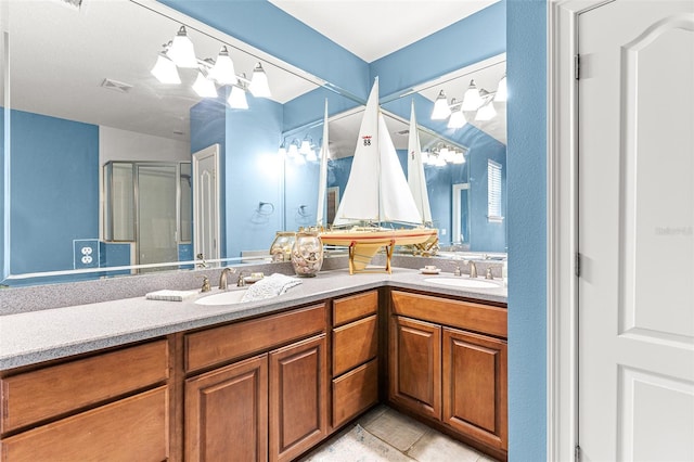 bathroom featuring a stall shower, a sink, and double vanity