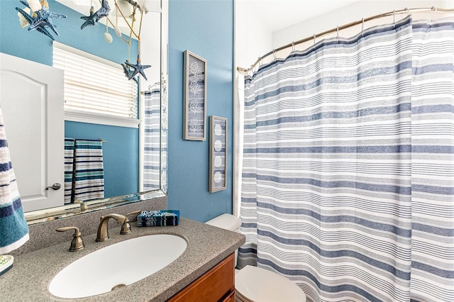 full bathroom with toilet, a shower with shower curtain, and vanity