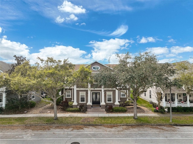 view of front of property with uncovered parking and stucco siding