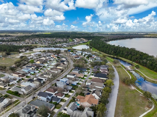 drone / aerial view with a residential view and a water view