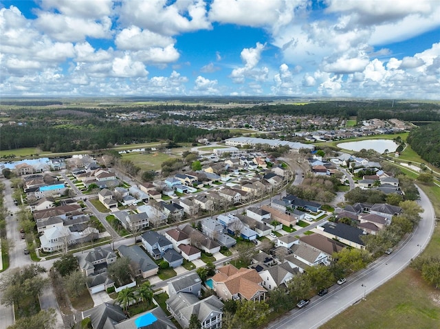 birds eye view of property with a water view and a residential view