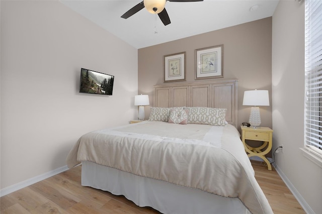 bedroom with multiple windows, ceiling fan, and light hardwood / wood-style flooring