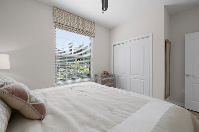 bedroom featuring ceiling fan and a closet