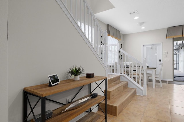 stairway with tile patterned flooring