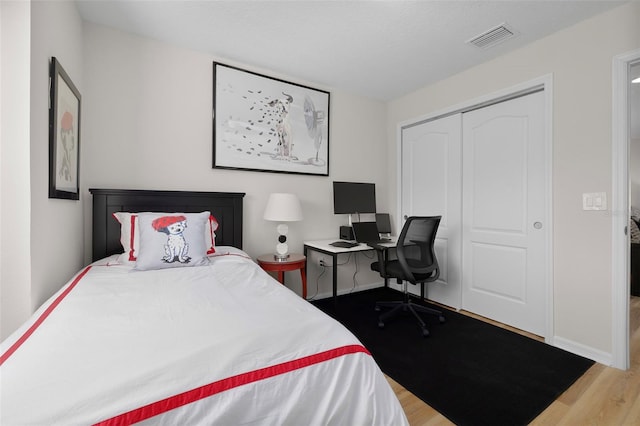 bedroom featuring light hardwood / wood-style flooring and a closet