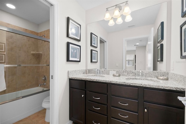 full bathroom featuring tile patterned flooring, enclosed tub / shower combo, vanity, and toilet