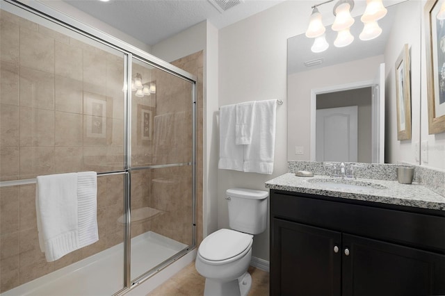 bathroom featuring an enclosed shower, vanity, and toilet