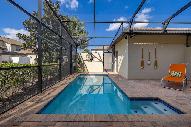 view of swimming pool with a patio and glass enclosure