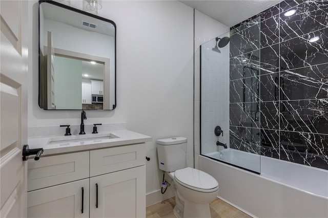 full bath with visible vents, toilet, combined bath / shower with glass door, vanity, and wood finished floors