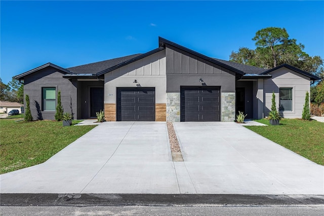 modern inspired farmhouse with an attached garage, stone siding, a front lawn, and board and batten siding