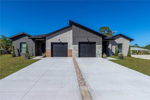 view of front facade featuring a garage, concrete driveway, stone siding, a front lawn, and board and batten siding