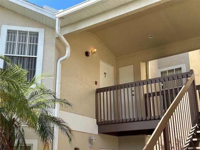 view of exterior entry featuring a balcony