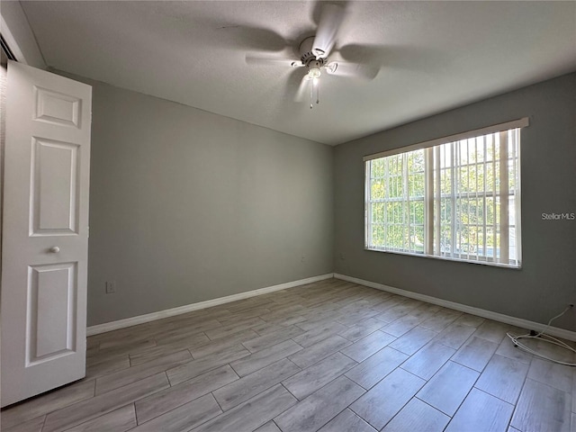 unfurnished room with ceiling fan