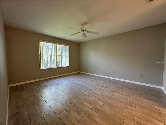 spare room with ceiling fan and light wood-type flooring