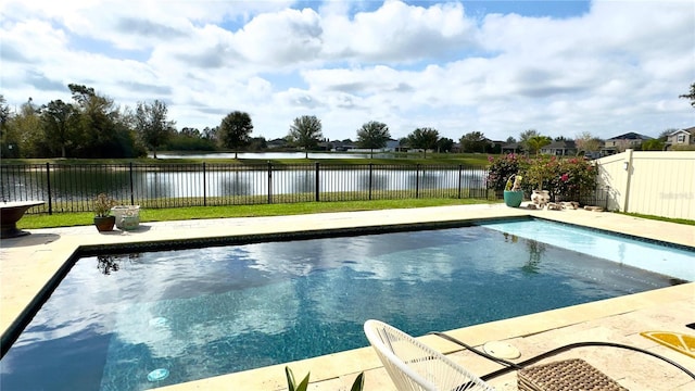 view of pool featuring a water view and a patio area