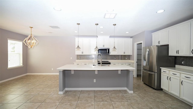 kitchen with a sink, light countertops, visible vents, and stainless steel appliances