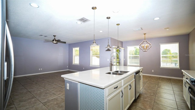 kitchen featuring visible vents, ceiling fan, light countertops, stainless steel appliances, and a sink