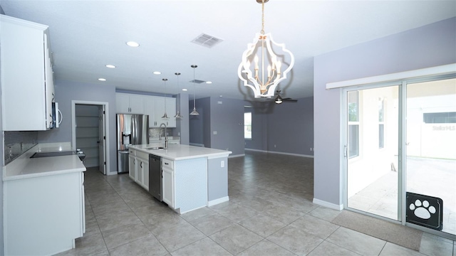 kitchen featuring a sink, light countertops, visible vents, and stainless steel appliances