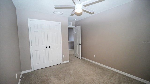 unfurnished bedroom with carpet, visible vents, a closet, and baseboards