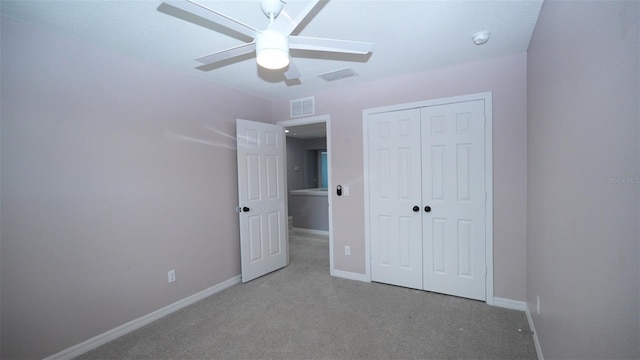 unfurnished bedroom with visible vents, a closet, carpet floors, baseboards, and ceiling fan